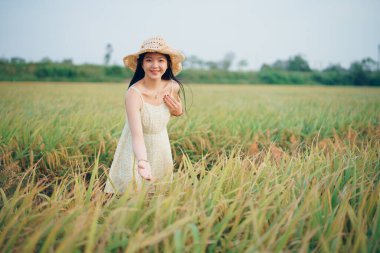 Relaxed brunette girl walking on rice fields