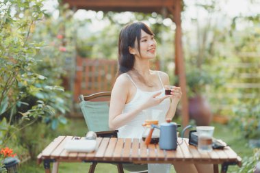 Kız avluda kahve yapıyor.