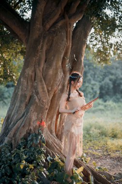 Nostaljik tema, ağacın altında flüt çalan kız.