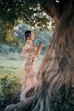 Nostaljik tema, ağacın altında flüt çalan kız.