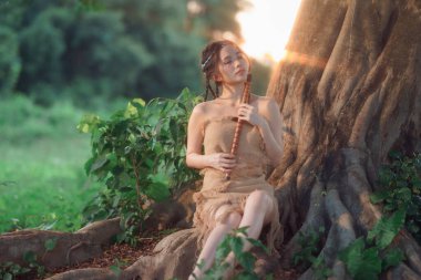 Nostaljik tema, ağacın altında flüt çalan kız.