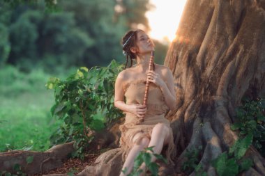 Nostaljik tema, ağacın altında flüt çalan kız.