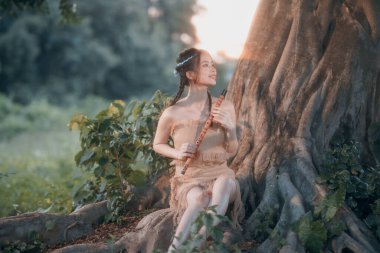 Nostaljik tema, ağacın altında flüt çalan kız.