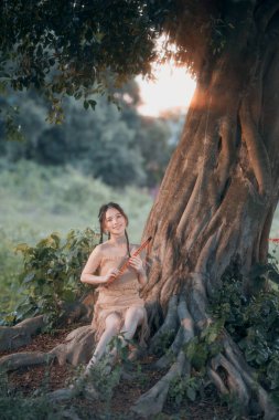 Nostaljik tema, ağacın altında flüt çalan kız.