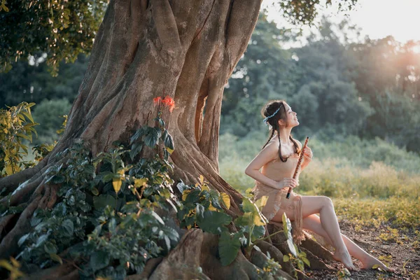 stock image Nostalgic theme, girl playing flute under tree