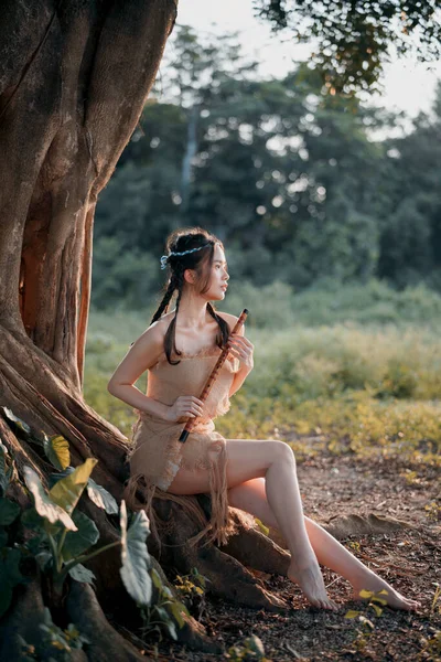 Stock image Nostalgic theme, girl playing flute under tree