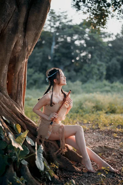 stock image Nostalgic theme, girl playing flute under tree