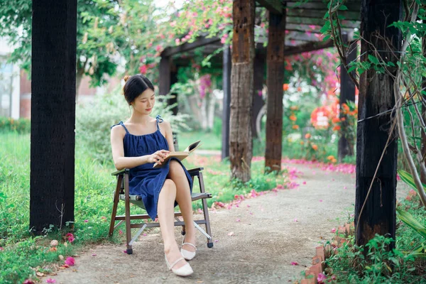 stock image the girl is reading in the yard