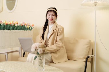 Kız sütlü çay dükkanında tablet bilgisayar kullanıyor.