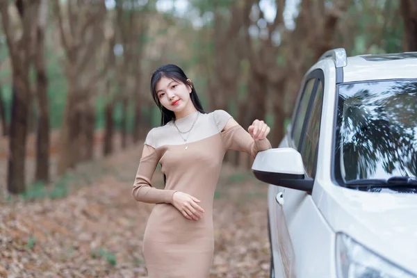 stock image The girl driver is beside the car