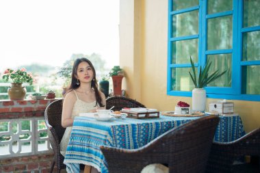 Kız bahçede kitap okuyor.