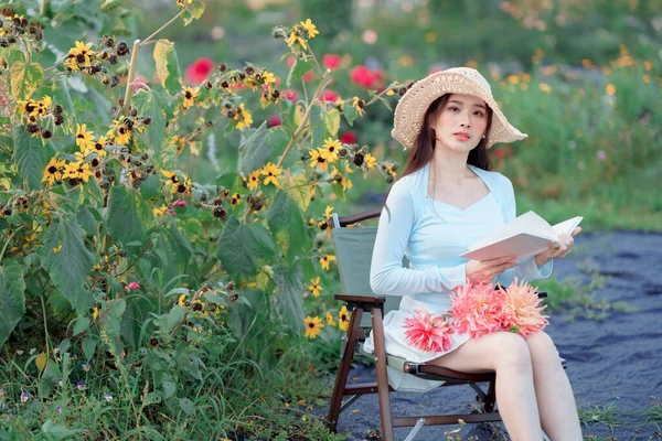 Young girls read books in the garden