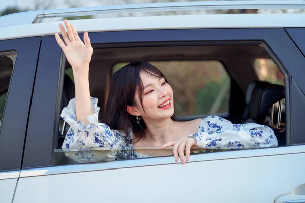 Fashionable Asian girls make up in the car