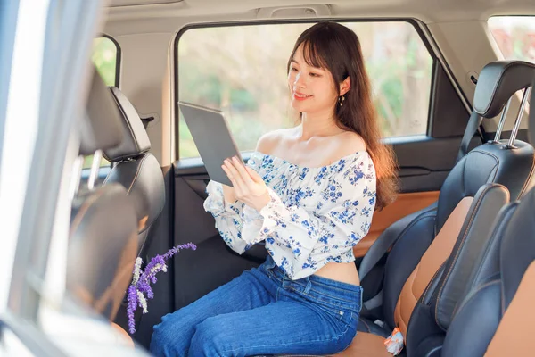 Fashionable Asian girls make up in the car