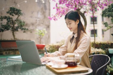 Asyalı kızlar avluda çalışıyor.