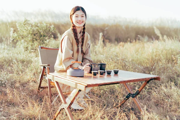 Asian girls make tea at camp