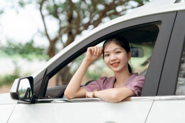 Yeni başlayan bir kadın sürücü arabada oturuyor.