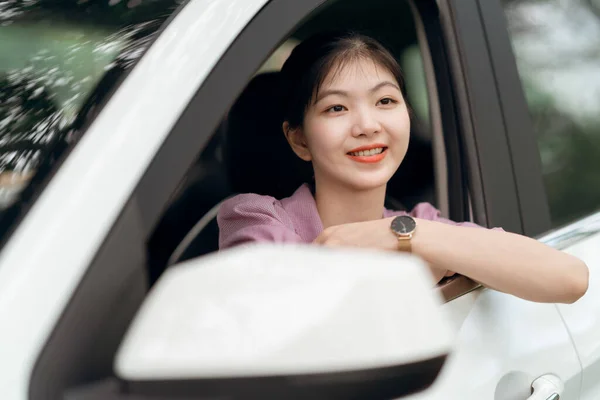 Female driver beginner sitting in a car