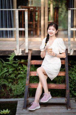 Bayan üniversite öğrencileri kampüste dizüstü bilgisayar kullanıyorlar.