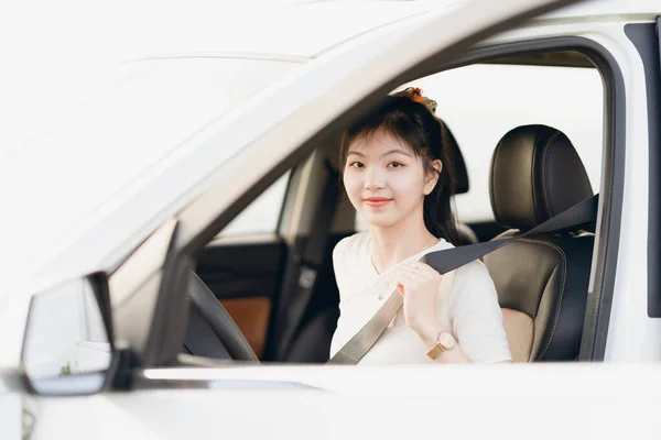 Female driver beginner sitting in a car