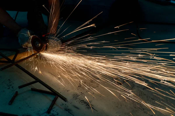 metal cutting saw close up throwing sparks all over in a workshop