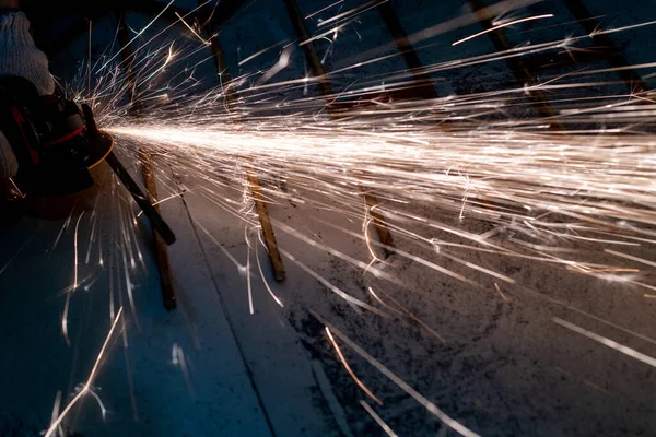 metal cutting saw close up throwing sparks all over in a workshop