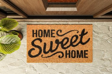 Home Sweet Home doormat on the porch at the front door. clipart