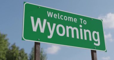 Mavi gökyüzü ve bulutlara karşı Wyoming Yeşil Yol Tabelasına hoş geldiniz..