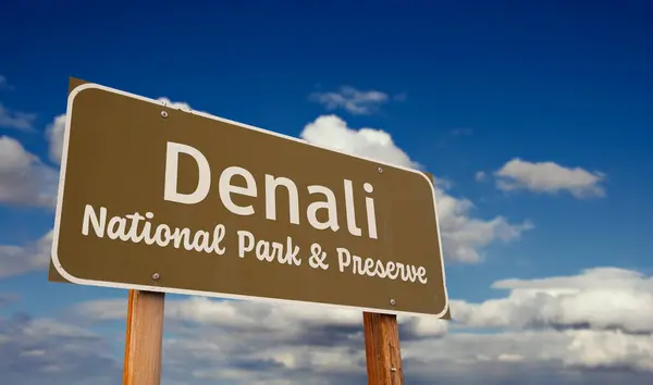 stock image Denali National Park & Preserve (Alaska) Road Sign Against Blue Sky and Clouds.