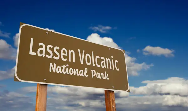 stock image Lassen Volcanic National Park (California) Road Sign Against Blue Sky and Clouds.