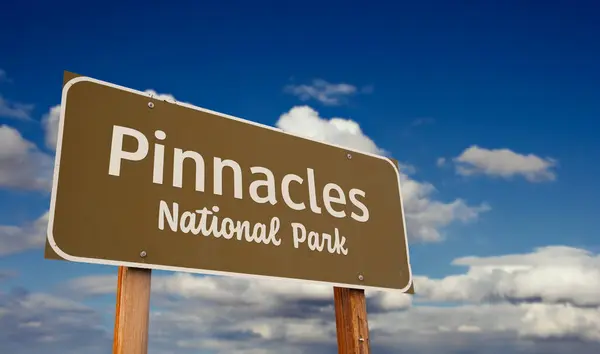 stock image Pinnacles National Park (California) Road Sign Against Blue Sky and Clouds.