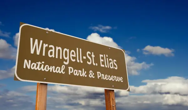 stock image Wrangell-St. Elias National Park and Preserve (Alaska) Road Sign Against Blue Sky and Clouds.