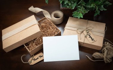 Gift Packaging Boxes Mock Up with Jute String, Thank You and Congratulations Card and Tags with Small Key on Wood Surface. clipart