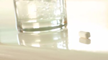 Tescilli olmayan ilaç şişelerinin 4K Yavaş Pan 'ı ve banyo tezgahındaki haplar.