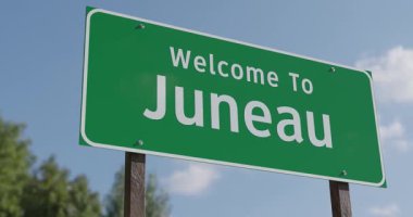 Juneau, Alaska 'ya Hoş Geldiniz Mavi Gök ve Bulutlara Karşı Yeşil Yol İşareti.