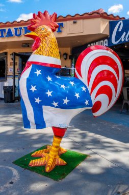 MIAMI, USA - FEBRUARY 7, 2023 : Famous rooster with an american flag in Little Havana, heart of the cuban community in Miami