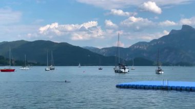 Mondsee, Yukarı Avusturya, 25 Haziran 2024: Ziyaretçiler, Mondsee kasabasındaki popüler bir göl kenti olan Alpenseebad Mondsee 'de güneşli bir yaz gününün tadını çıkarıyorlar