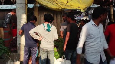 Bangladeş 'in önde gelen şehirlerinden biri olan Rangpur' daki Pouro Bazar pazarında kimliği belirsiz kişiler.