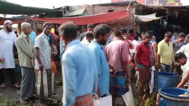 Bangladeş 'in önde gelen şehirlerinden biri olan Rangpur' daki Pouro Bazar pazarında kimliği belirsiz kişiler.