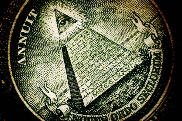 All Seeing Eye pyramid on back of dollar bill american money on old weathered paper