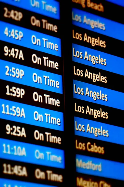 Airline flights information board in airport with arrivals and departures for traveling Los Angeles
