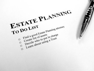 Written Estate Planning to do list on desk with pen clipart