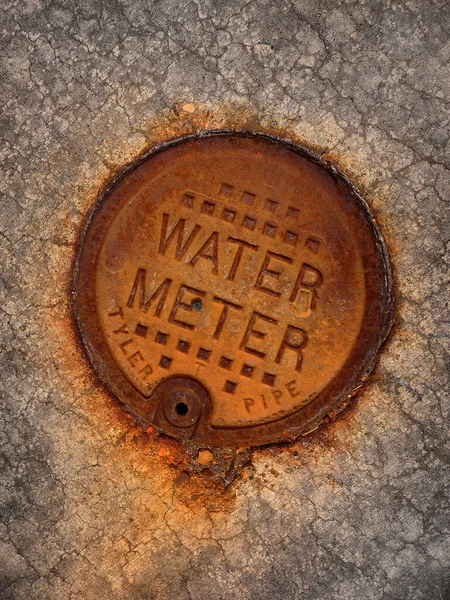 Detail of weathered rusted water meter cover texture