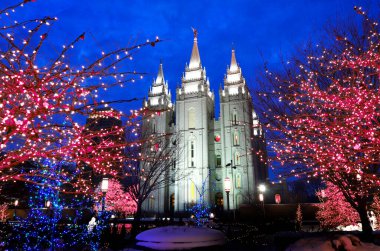 Salt Lake City Temple during the Holidays with Christmas Lights on Trees for Decorations clipart