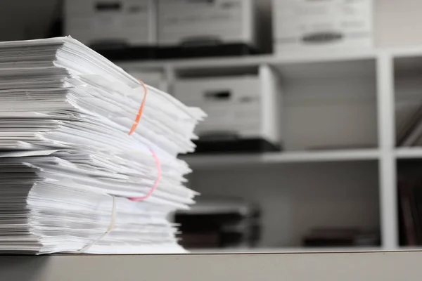 Files organized on an office shelf for clients papers and information