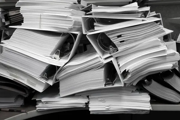 stock image Messy office with pile of binders holding papers and filings disorganized mess