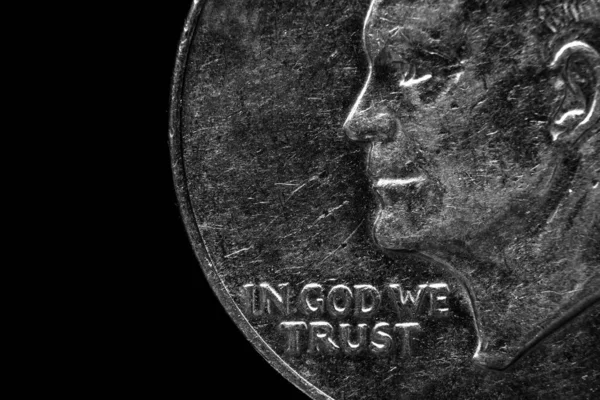Closeup of US coins In God We Trust worn old texture silver