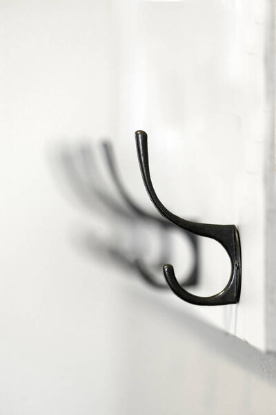 Detail of coat rack or hanging hooks on wall of house