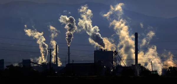 Factory creating pollution and smoke into the air from a smokestack pollute