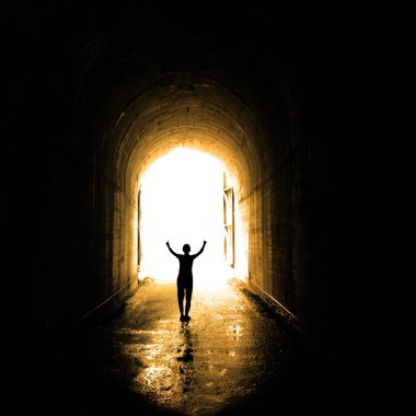 Single individual person at end of tunnel for success and triumph at end of journey